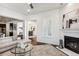 Living room with fireplace and open floor plan to kitchen and dining area at 9167 E 35Th Ave, Denver, CO 80238