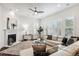 Spacious living room with a fireplace and large windows with plantation shutters at 9167 E 35Th Ave, Denver, CO 80238