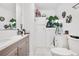 Clean bathroom with single sink vanity, linen cabinet, and toilet at 6440 - 6450 W 35Th Ave, Wheat Ridge, CO 80033