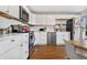 Modern white kitchen with stainless steel appliances at 6440 - 6450 W 35Th Ave, Wheat Ridge, CO 80033