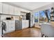 Updated kitchen featuring white cabinets and hardwood floors at 6440 - 6450 W 35Th Ave, Wheat Ridge, CO 80033