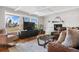 Living room featuring a fireplace, hardwood floors, and ample natural light at 6440 - 6450 W 35Th Ave, Wheat Ridge, CO 80033