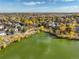 Aerial view of community pond, fall trees, and neighborhood homes at 10971 Bryant St, Westminster, CO 80234