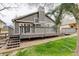 Wooden deck with steps down to a grassy yard and rock landscaping, offering peaceful outdoor living at 10971 Bryant St, Westminster, CO 80234