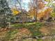 Fall view of the home's spacious deck and large backyard with mature trees at 10971 Bryant St, Westminster, CO 80234
