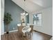 Cozy dining area with modern lighting, hardwood floors, and stylish chairs, adjacent to the kitchen at 10971 Bryant St, Westminster, CO 80234
