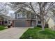 Charming two-story home with gray siding, brick accents, well-kept lawn, and a two-car garage at 10971 Bryant St, Westminster, CO 80234