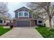 Well-maintained two-story house with a gray exterior, attached two-car garage, and manicured front lawn at 10971 Bryant St, Westminster, CO 80234
