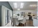 Bright kitchen and dining area with stainless steel appliances and skylights at 10971 Bryant St, Westminster, CO 80234
