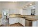 Bright kitchen features white cabinets, granite countertops, and stainless steel appliances at 10971 Bryant St, Westminster, CO 80234
