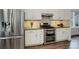 Modern kitchen with stainless steel appliances and white cabinets offers ample counter space at 10971 Bryant St, Westminster, CO 80234
