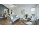 Inviting living room with vaulted ceilings, hardwood floors, and stylish furniture adjacent to the dining area at 10971 Bryant St, Westminster, CO 80234