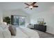 Vaulted main bedroom with a sliding door leading to a deck and an accent chair at 10971 Bryant St, Westminster, CO 80234