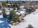 Two-story home with deck and snowy backyard, surrounded by trees at 6017 Thunder Hill Rd, Parker, CO 80134