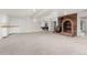 Spacious basement recreation area with brick fireplace and wet bar at 6017 Thunder Hill Rd, Parker, CO 80134