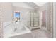 Bathroom with soaking tub and shower at 6017 Thunder Hill Rd, Parker, CO 80134