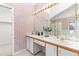Bathroom with double vanity and floral wallpaper at 6017 Thunder Hill Rd, Parker, CO 80134