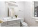 Powder room with floral wallpaper, toilet and vanity at 6017 Thunder Hill Rd, Parker, CO 80134