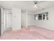 Bright bedroom with pink carpet, double closets and access to a bathroom at 6017 Thunder Hill Rd, Parker, CO 80134