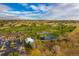 Aerial view of a beautiful golf course with a clubhouse and pond at 6017 Thunder Hill Rd, Parker, CO 80134