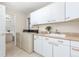 Laundry room with washer, dryer, cabinets and sink at 6017 Thunder Hill Rd, Parker, CO 80134