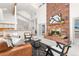 Open living room with a brick fireplace and view to kitchen at 6017 Thunder Hill Rd, Parker, CO 80134