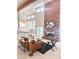 Sunlit living room with a two story brick fireplace and access to deck at 6017 Thunder Hill Rd, Parker, CO 80134