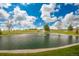 Serene pond with fountain, surrounded by lush greenery and a beautiful landscape at 6017 Thunder Hill Rd, Parker, CO 80134