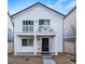 Charming two-story home featuring a quaint balcony and a well-maintained front yard with rock landscaping at 13585 E 103Rd Pl, Commerce City, CO 80022