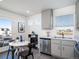 Eat-in kitchen features stainless appliances, grey cabinets, and a bright eating area with modern decor at 13585 E 103Rd Pl, Commerce City, CO 80022