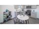 Modern kitchen with stainless appliances, grey cabinets, and a charming dining nook with stylish accents at 13585 E 103Rd Pl, Commerce City, CO 80022