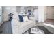 Open-concept living room with a couch and kitchen in background at 13585 E 103Rd Pl, Commerce City, CO 80022