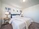 Comfortable primary bedroom with carpet, stylish decor, bedside tables, and ample natural light at 13585 E 103Rd Pl, Commerce City, CO 80022