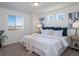 Primary bedroom offers bright windows, neutral tones, bedside tables, and a calm, inviting atmosphere at 13585 E 103Rd Pl, Commerce City, CO 80022
