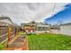 Backyard features a fenced yard, a patio with chairs, and a sunroom addition at 7861 Osceola St, Westminster, CO 80030