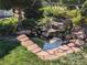 Backyard shows a serene pond surrounded by rocks and greenery at 7861 Osceola St, Westminster, CO 80030