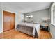 Bedroom with hardwood flooring, large bed and neutral colored walls at 7861 Osceola St, Westminster, CO 80030