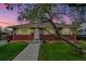 Charming brick home featuring a well-manicured lawn and a mature tree at 7861 Osceola St, Westminster, CO 80030