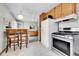 Functional kitchen featuring wood cabinets, tile counters, and modern stainless steel range at 7861 Osceola St, Westminster, CO 80030
