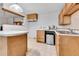 Compact kitchen includes a small refrigerator and a view to the next room over a peninsula counter at 7861 Osceola St, Westminster, CO 80030