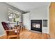 Living room showcasing hardwood floors, fireplace, large windows, and natural light at 7861 Osceola St, Westminster, CO 80030