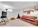 Finished basement with a sofa and carpet at 7861 Osceola St, Westminster, CO 80030