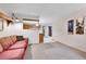 View of the living room with carpeted floors, neutral walls, and a peek into the adjacent kitchen at 7861 Osceola St, Westminster, CO 80030