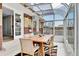 Bright sunroom with brick accent wall, skylight roof, and modern furnishings at 7861 Osceola St, Westminster, CO 80030
