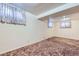Finished basement with carpet, windows, and drop ceiling at 10731 Rosalie Dr, Northglenn, CO 80233