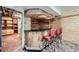Finished basement features a retro bar, carpeted floor, and shelving unit at 10731 Rosalie Dr, Northglenn, CO 80233
