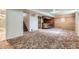 Finished basement features a retro bar, carpeted floor, and access to stairs and bathroom at 10731 Rosalie Dr, Northglenn, CO 80233