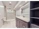 This updated bathroom has a glass door shower and vanity at 10731 Rosalie Dr, Northglenn, CO 80233