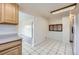 Bright kitchen area with tile floors, light cabinets, and open access to other rooms at 10731 Rosalie Dr, Northglenn, CO 80233