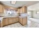 Well-lit kitchen featuring light-toned cabinets and a view of an adjacent living space at 10731 Rosalie Dr, Northglenn, CO 80233